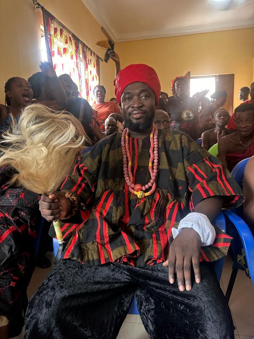 Togbe Edzeani V holding the ceremonial horsetail whisk of his office