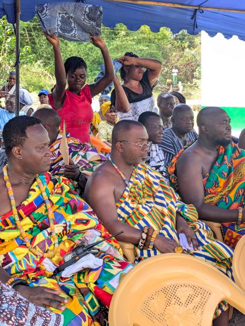 Chiefs in richly woven kente seated beneath the canopy.