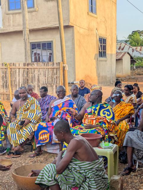 Chiefs and elders in conversation in the late afternoon light.