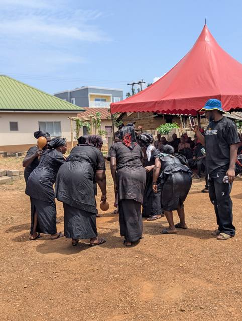 Women of Fodome dancing and shaking gourd rattles.