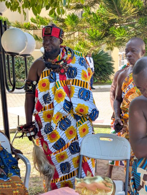 Togbe Edzeani V in white kente with embroidered motifs, standing among fellow traditional leaders.
