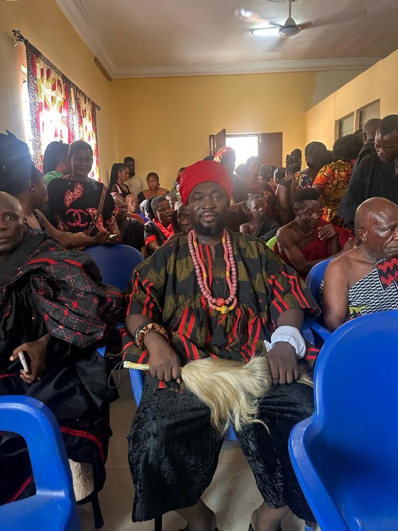 Togbe Edzeani V seated among the gathered community during his installation