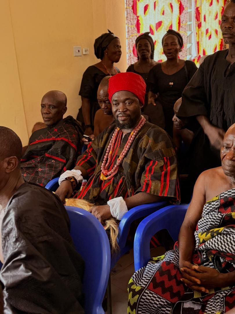 Togbe Edzeani V seated in traditional regalia during his installation ceremony, surrounded by chiefs and community members