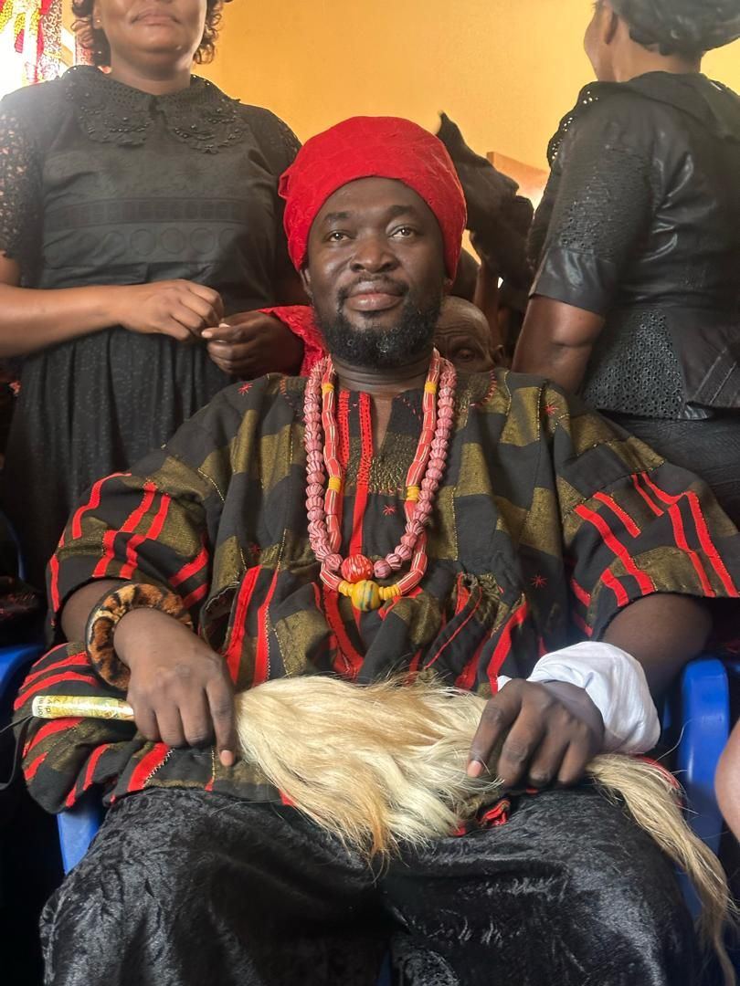 Portrait of Togbe Edzeani V in red headwrap and ceremonial beads